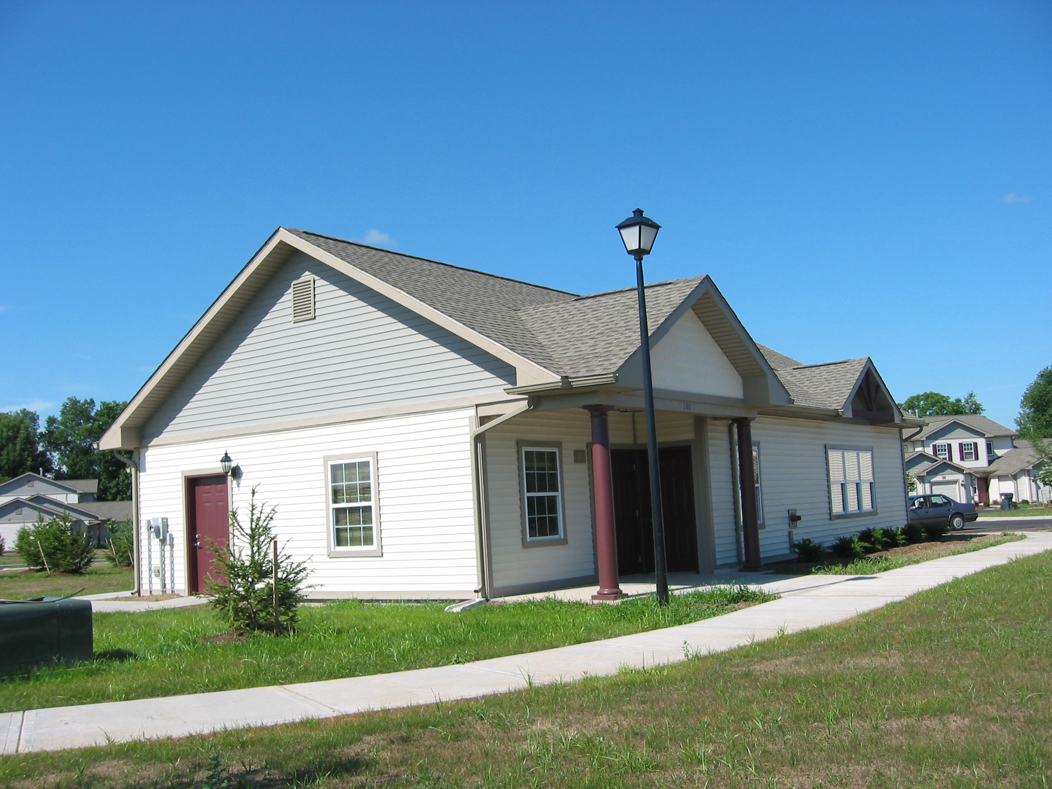 a white house with a street light in front of it