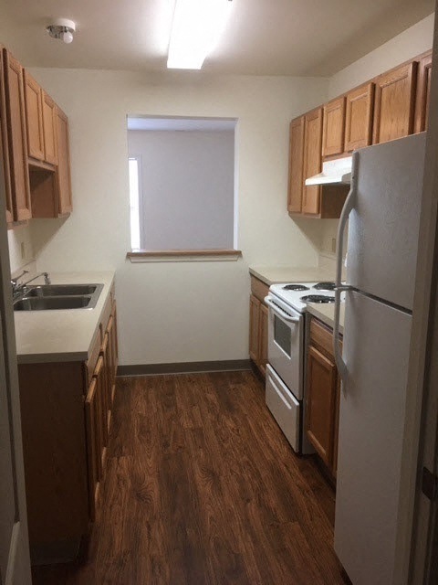 a small kitchen with a refrigerator and a sink