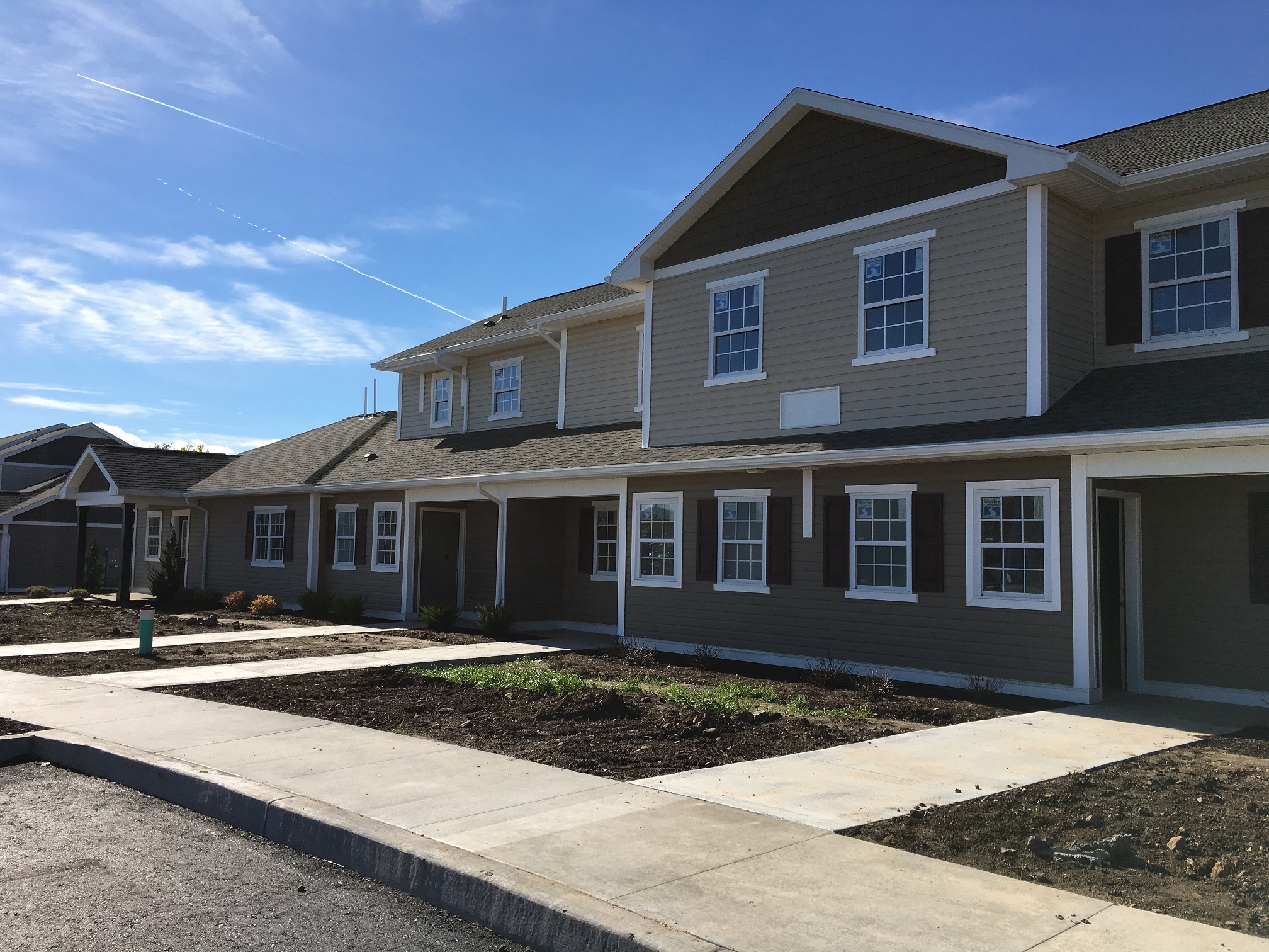 a large house with a sidewalk in front of it
