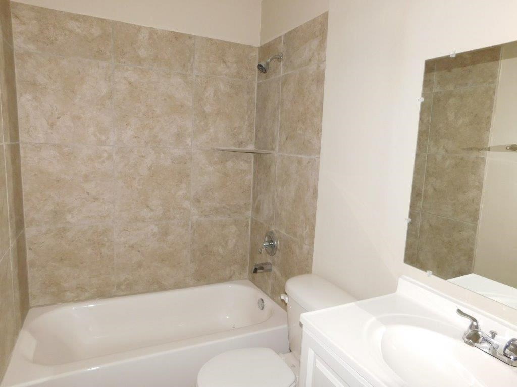 a bathroom with a sink toilet and a bath tub