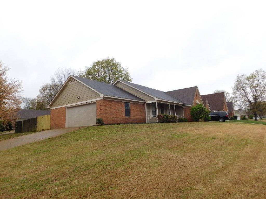 a house with a yard and a truck parked in front of it