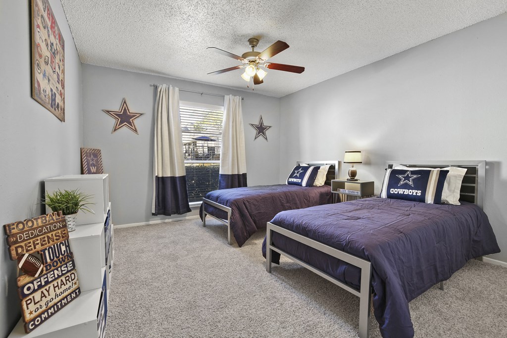 our second bedroom has two twin beds and a ceiling fan