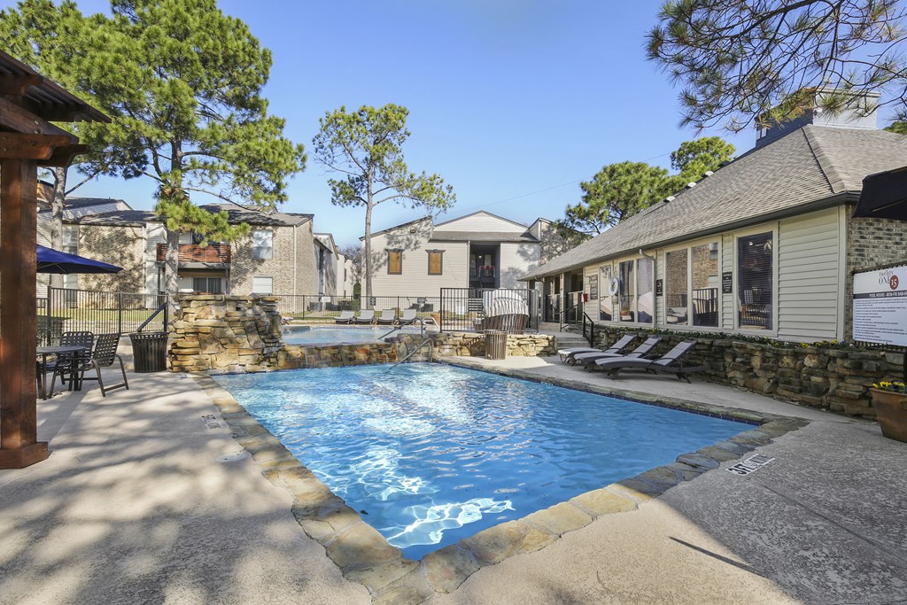 a swimming pool with a house in the background
