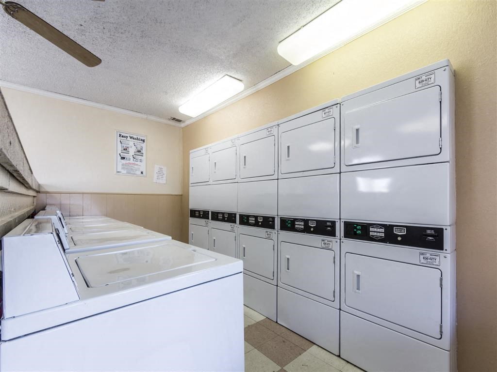 a laundry room with washes and dryers in it