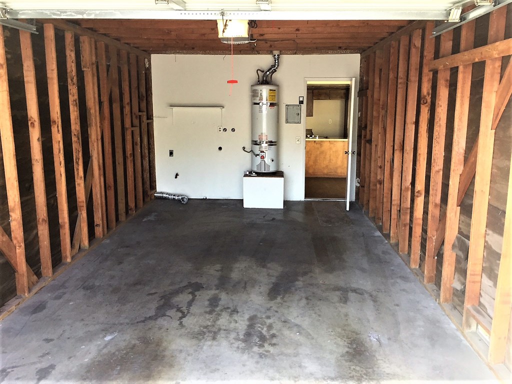 a room with wooden walls and a water tank in the middle of it