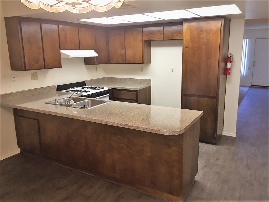 an empty kitchen with an island in the middle of it