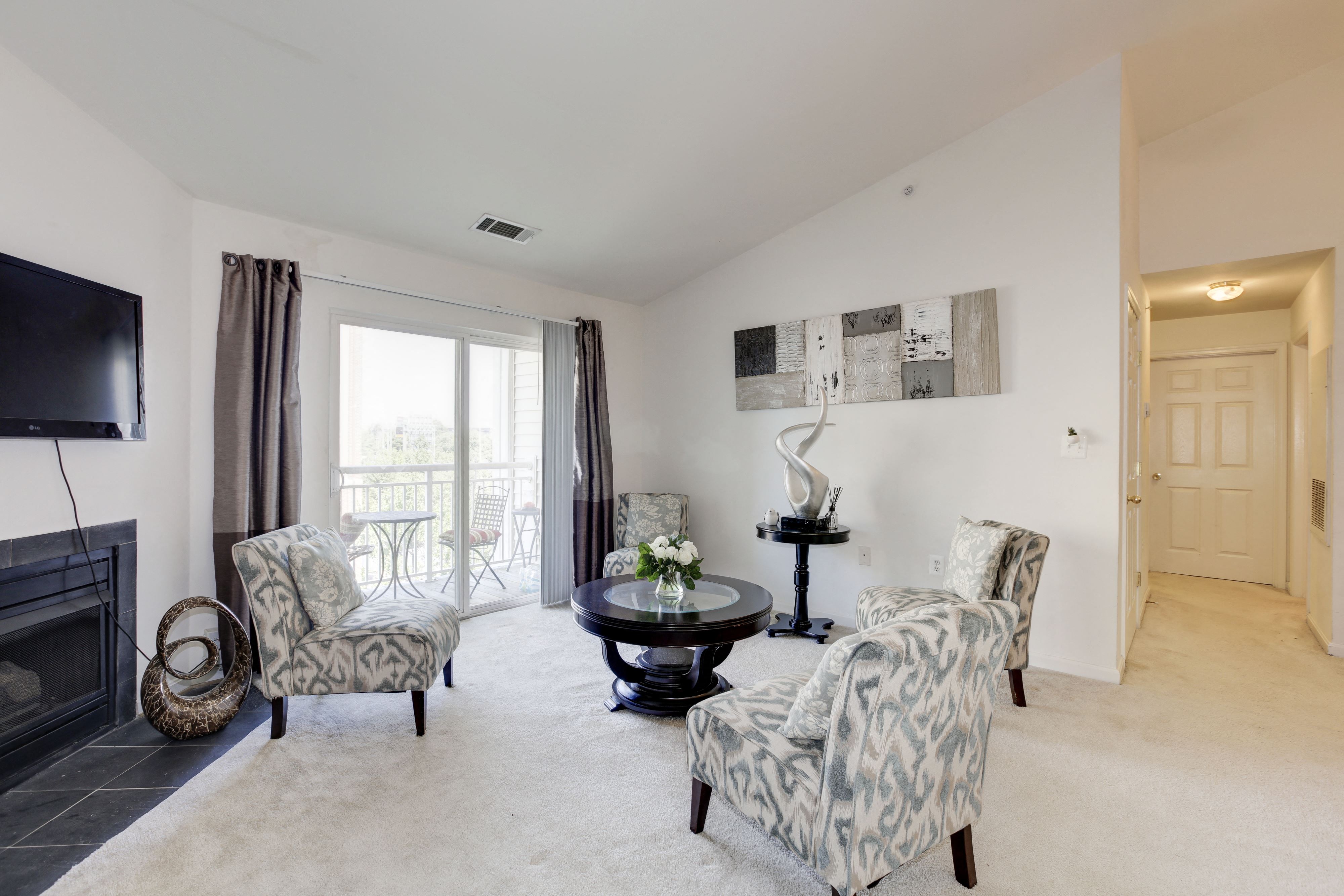 a living room with two chairs and a table and a television