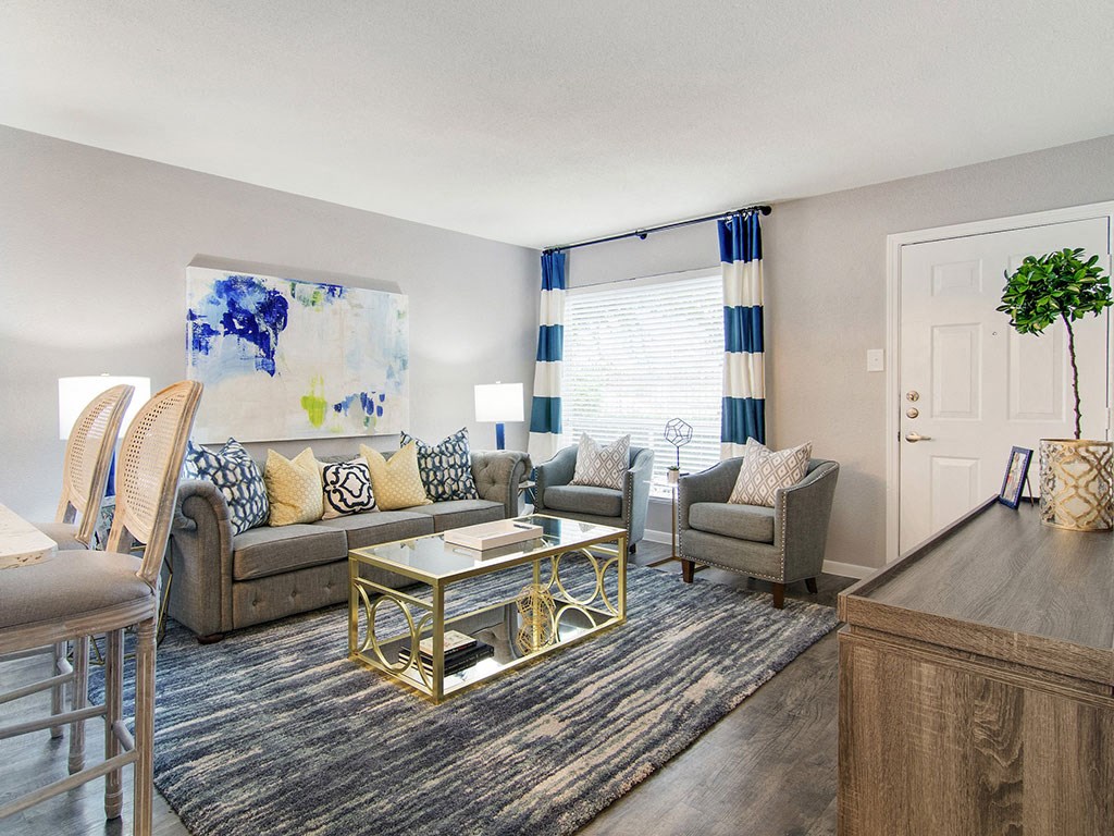 a living room with couches and chairs and a table