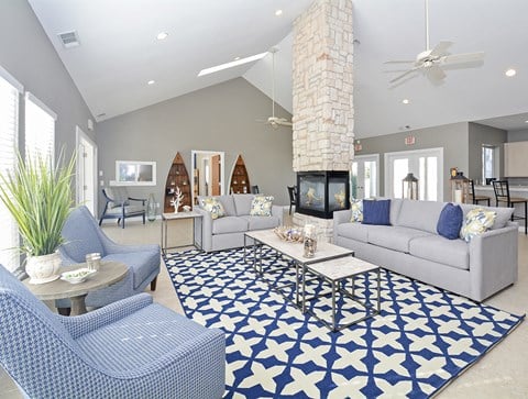 a living room with blue and white furniture and a fireplace