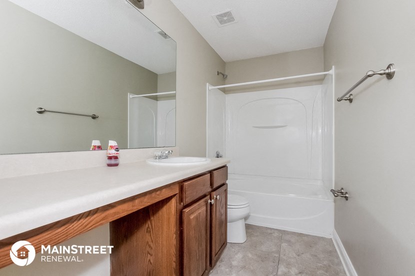 a bathroom with a sink and a toilet and a shower