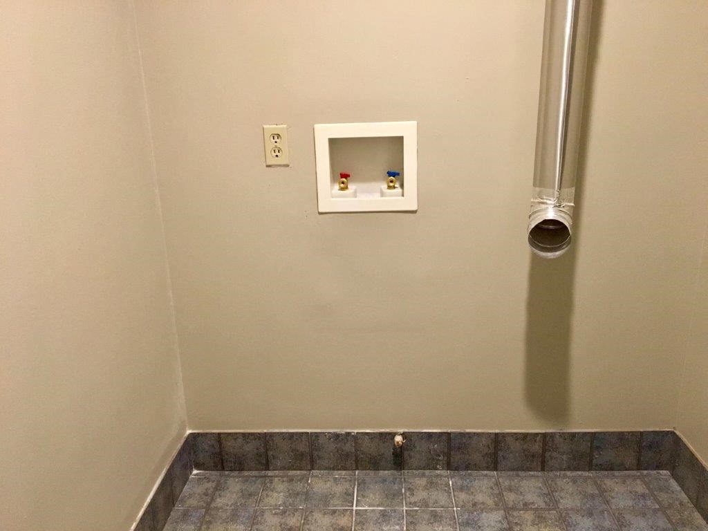 a wall with a heater and a pipe