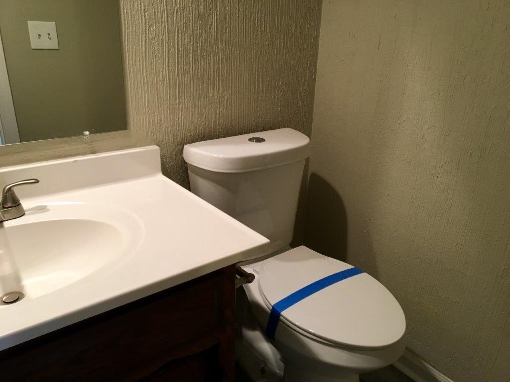 a bathroom with a toilet and a sink