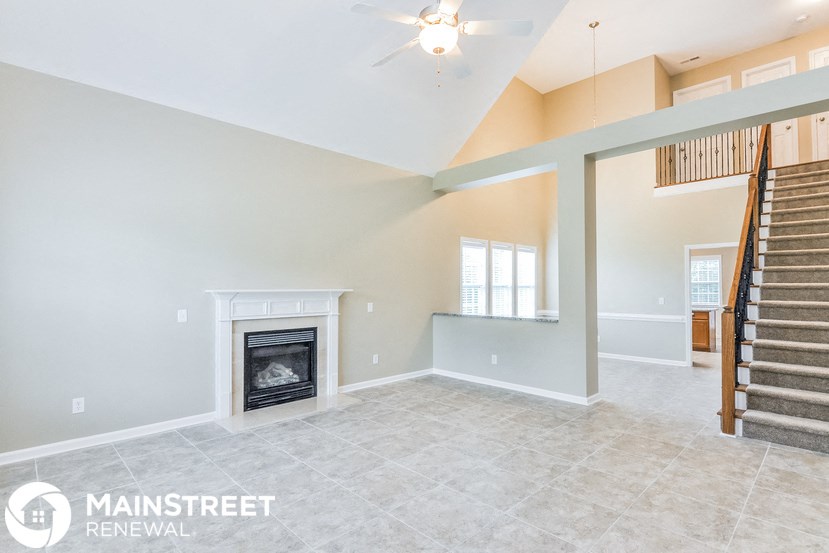 the living room has a fireplace and tile flooring