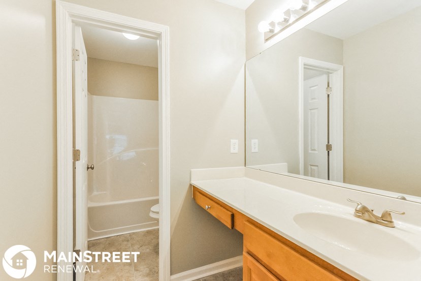 a bathroom with a sink and a mirror and a shower