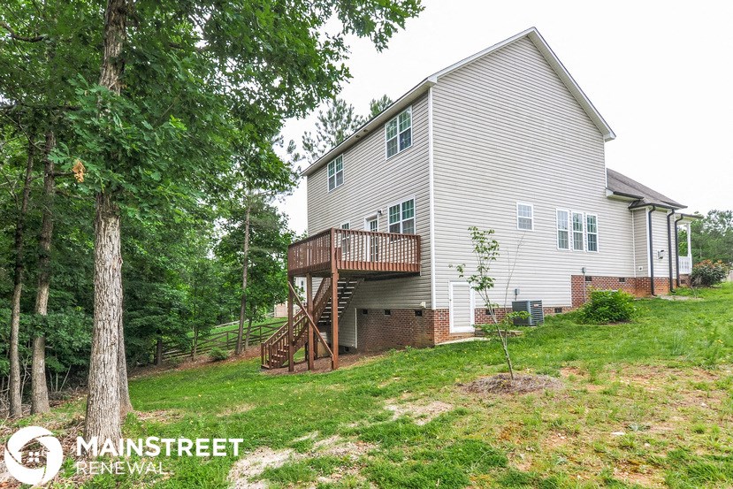 a home with a deck on the side of a house