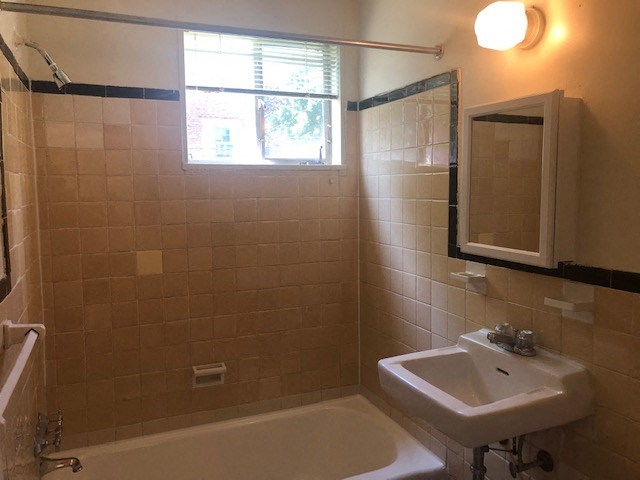 a bathroom with a sink and a mirror and a window