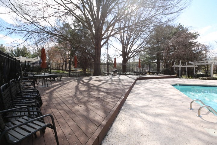 a swimming pool with benches next to it