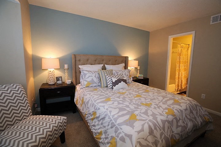 a bedroom with a bed and a chair