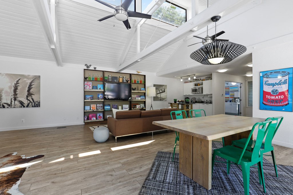 a dining room and living room with a table and chairs
