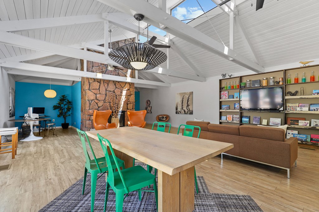 a dining room and living room with a table and chairs and a tv