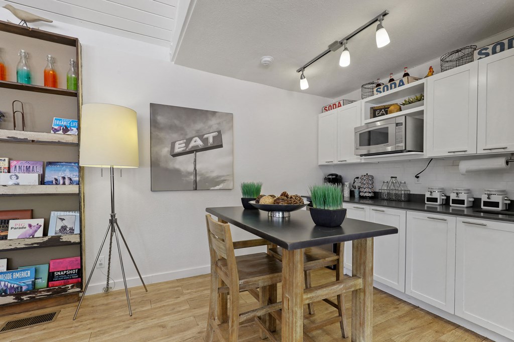 a kitchen with a table with two stools