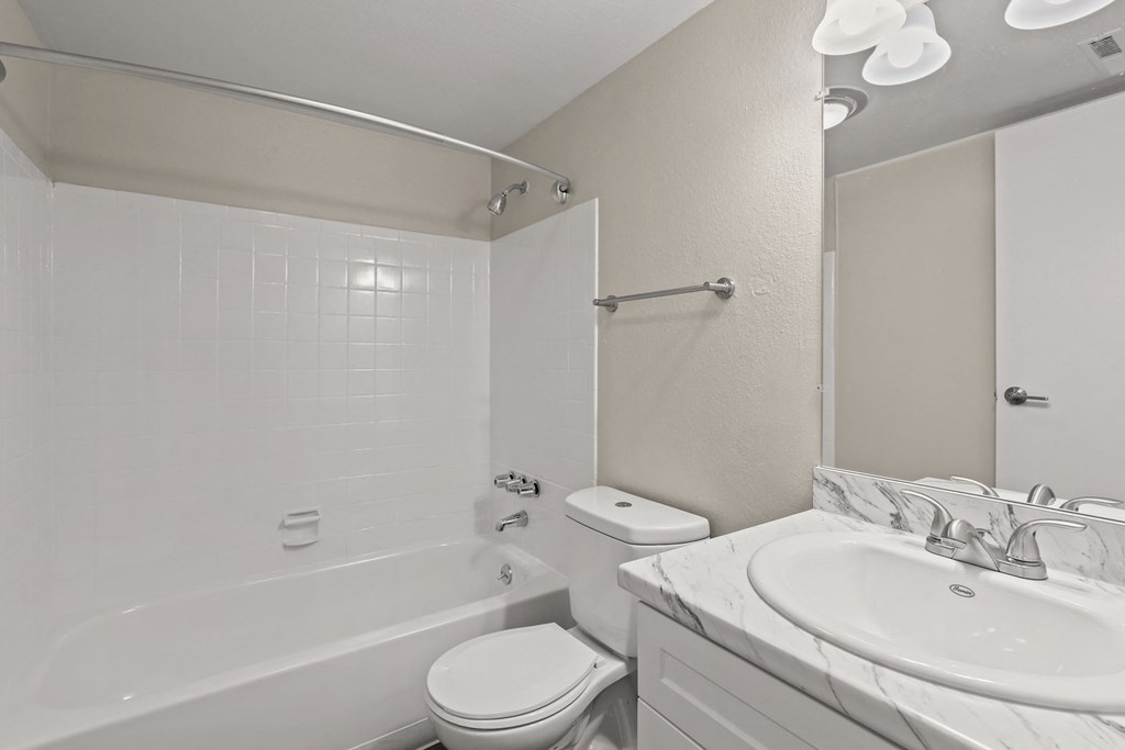 a bathroom with a sink toilet and bath tub