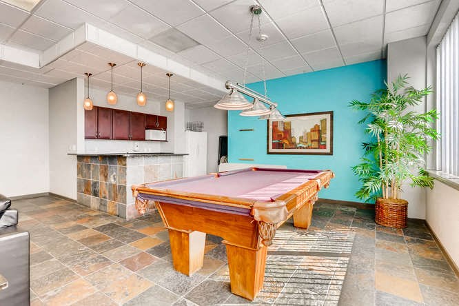 a game room with a pink pool table