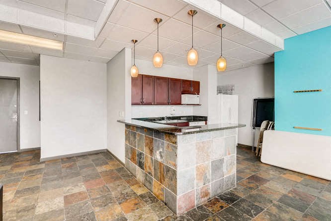 an empty kitchen with a counter top and