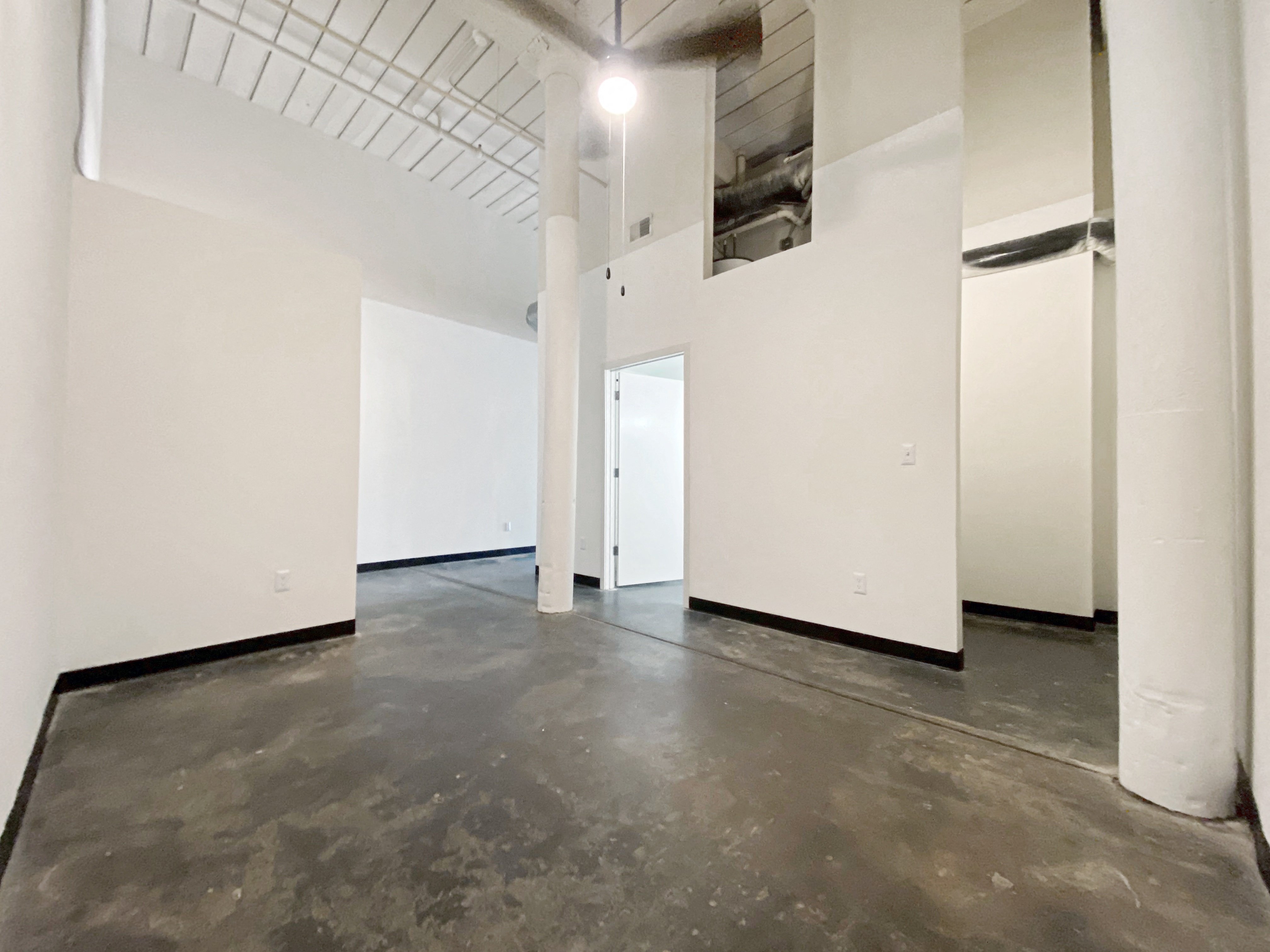 Main Bedroom with Polished Concrete Floors and Tall Ceilings