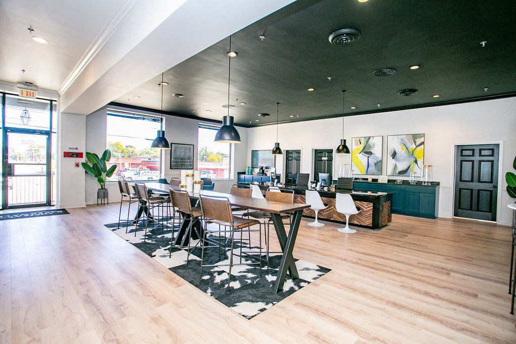 a dining room with tables and chairs and a living room