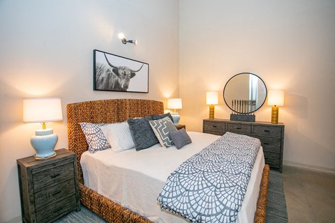 a bedroom with a bed and a mirror