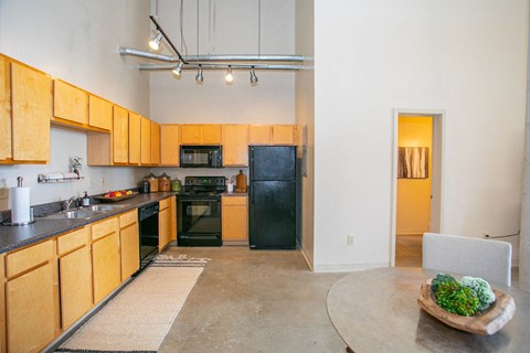 a kitchen with black appliances and wooden cabinets