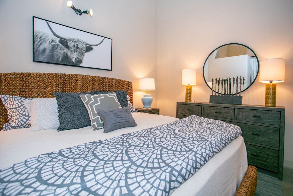 a bedroom with a bed and a mirror