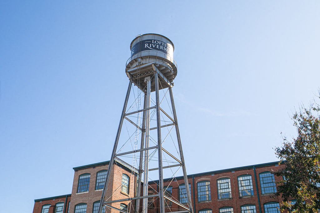 a water tower on top of a brick building