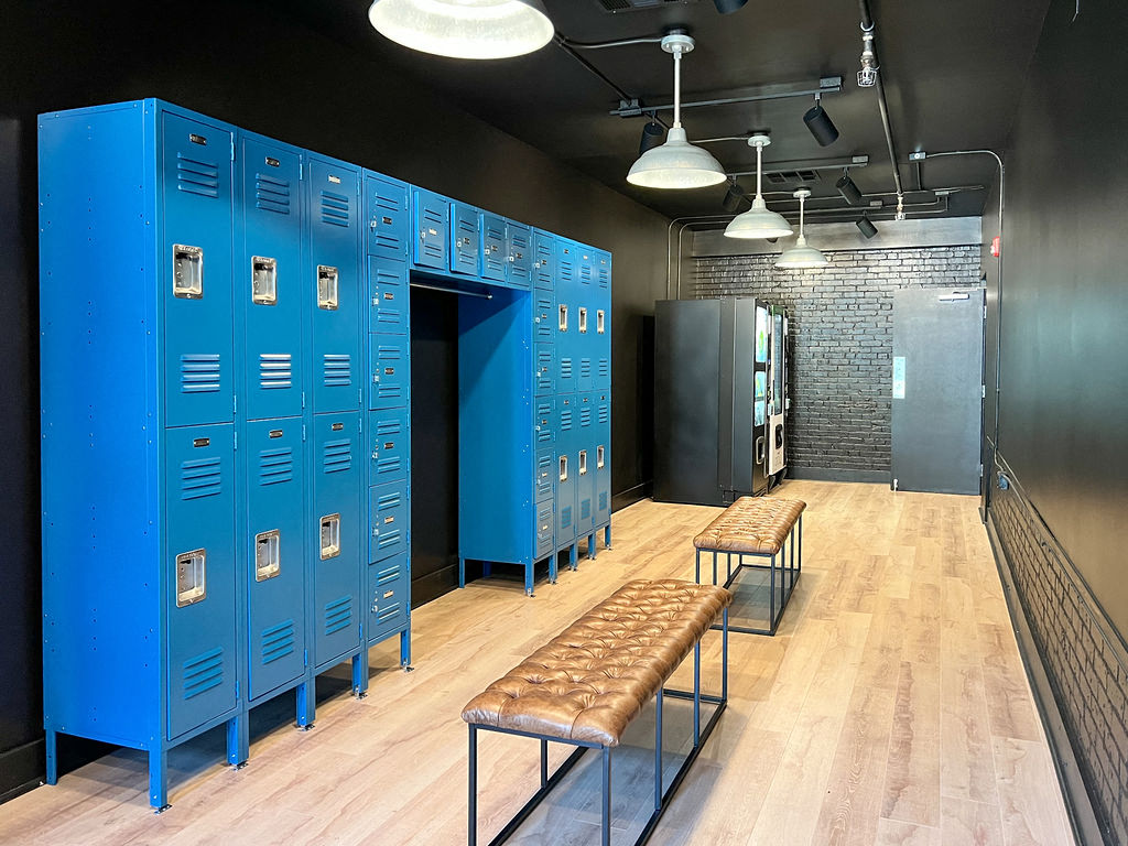 a locker room with blue lockers and benches