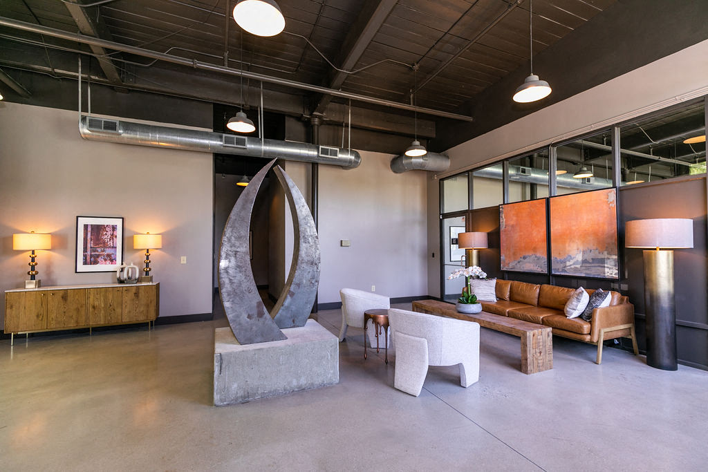 a living room with a sculpture in the middle