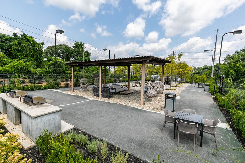 a picnic area with tables and chairs in a park