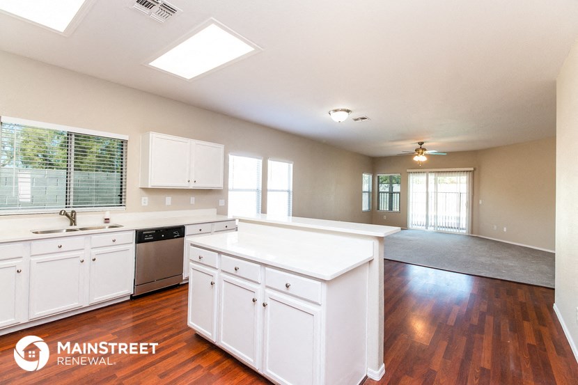 a large kitchen with white cabinets and a counter top