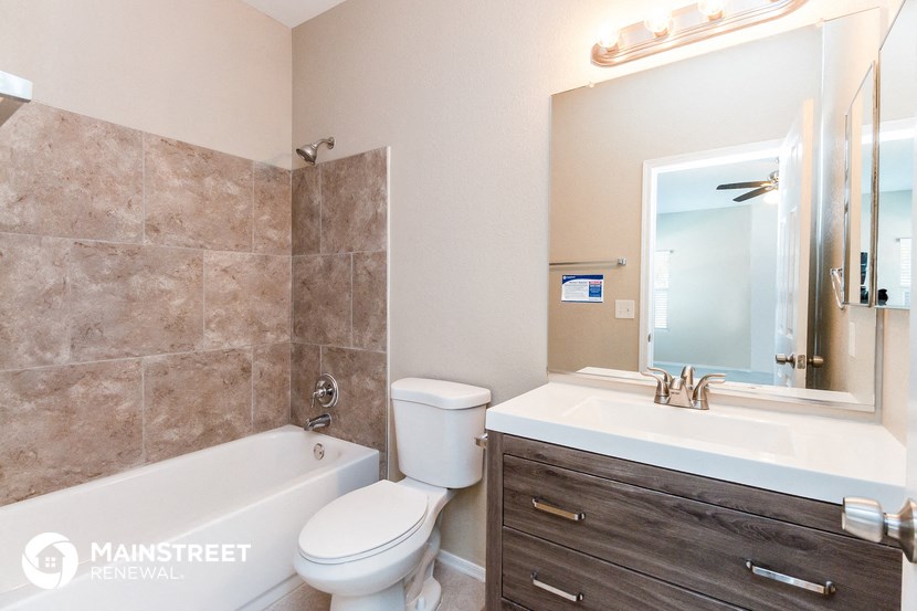 a bathroom with a sink toilet and a tub