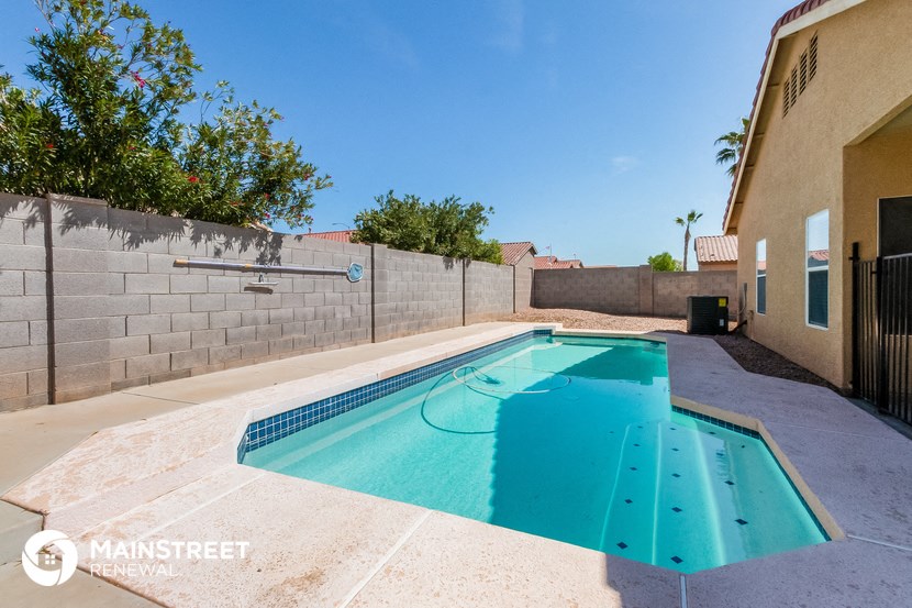 a swimming pool in the backyard of a house with a pool