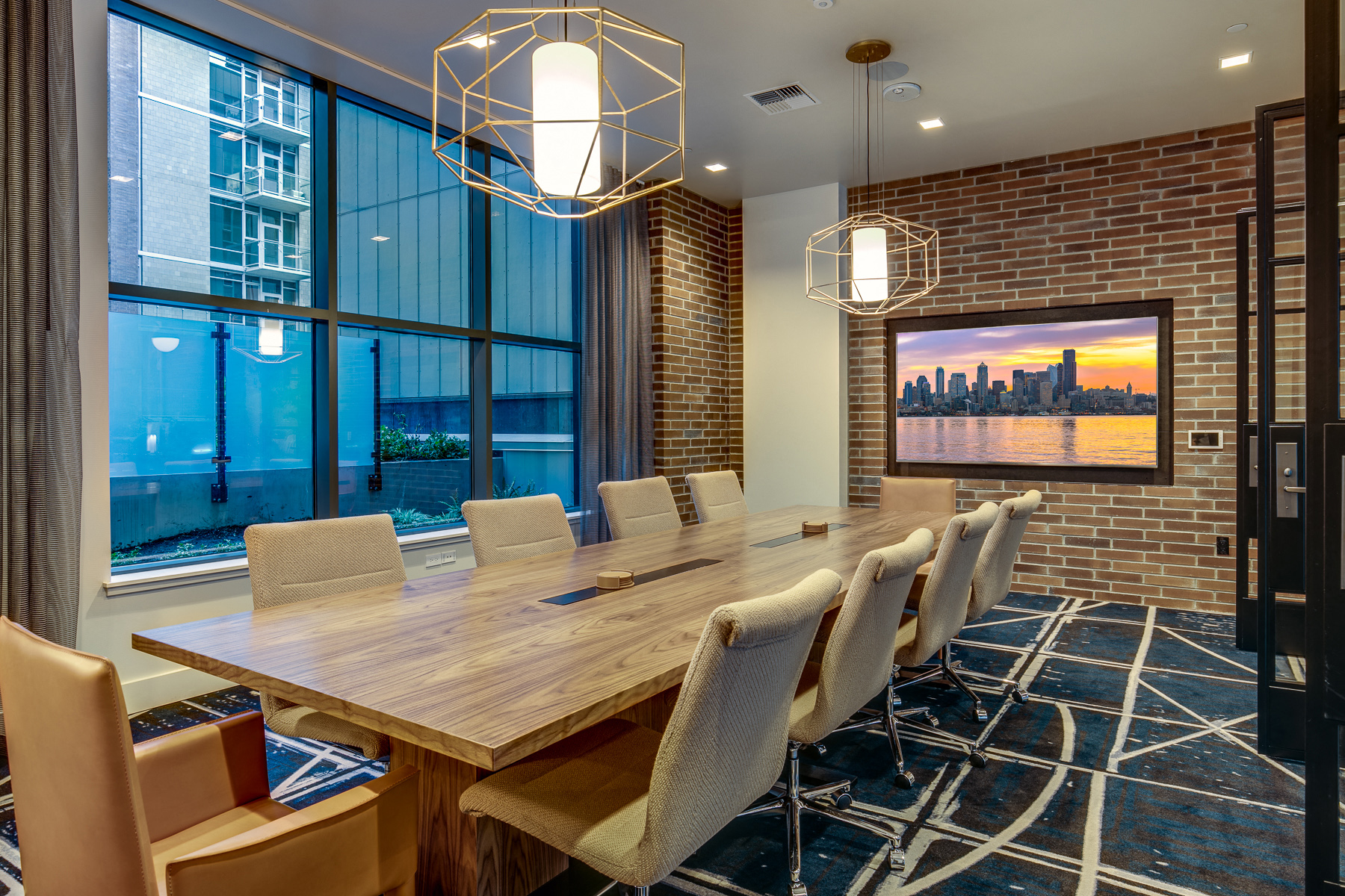 a conference room with a long wooden table and chairs and a large window
