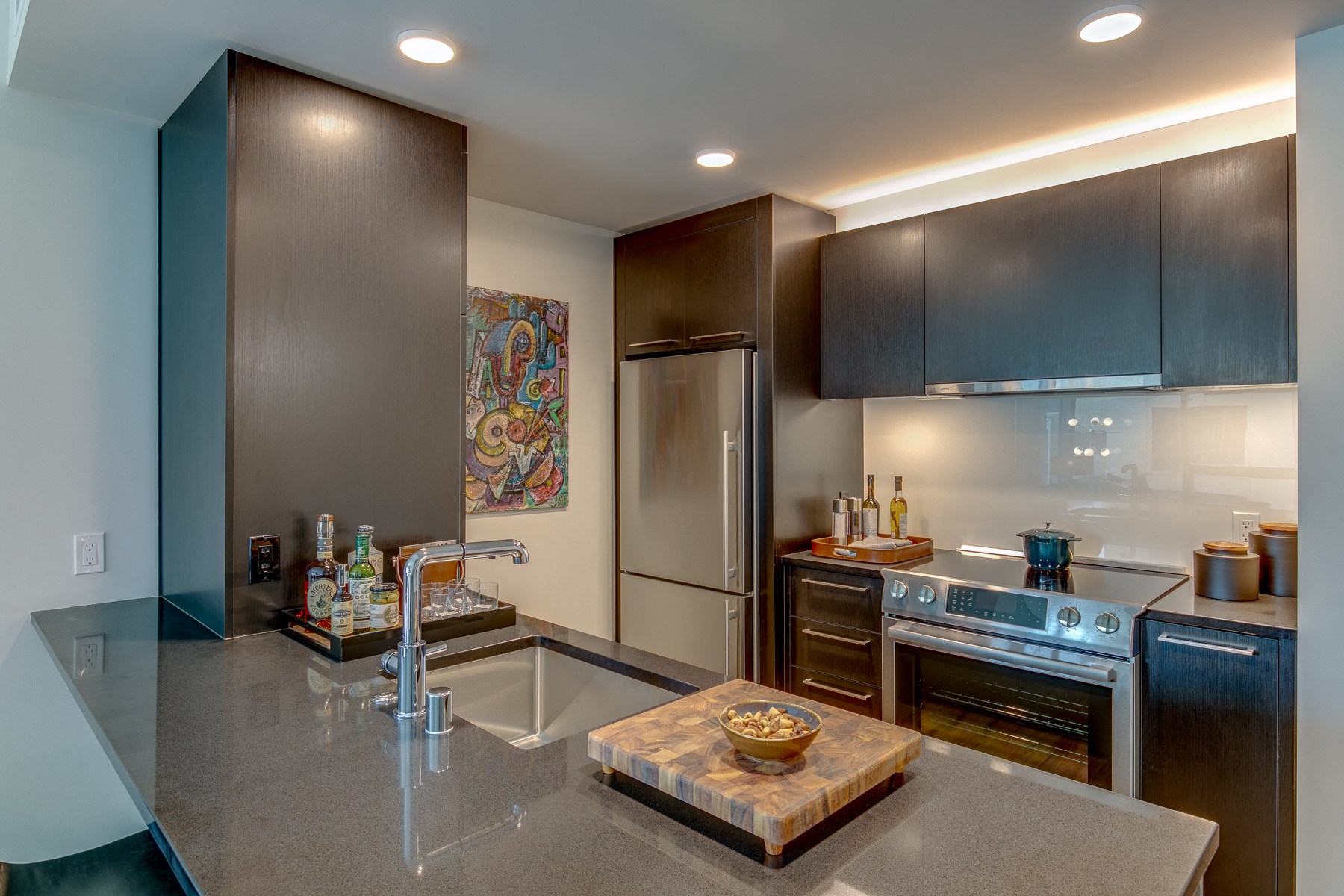 the kitchen has stainless steel appliances and granite counter tops