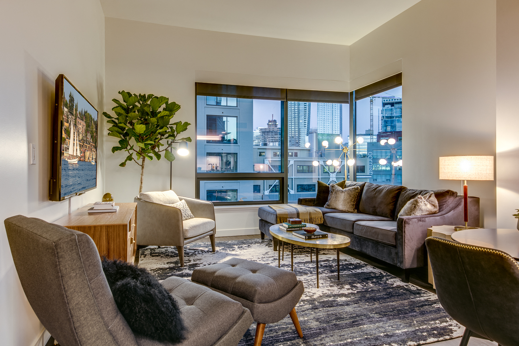 a living room with couches and chairs and a large window