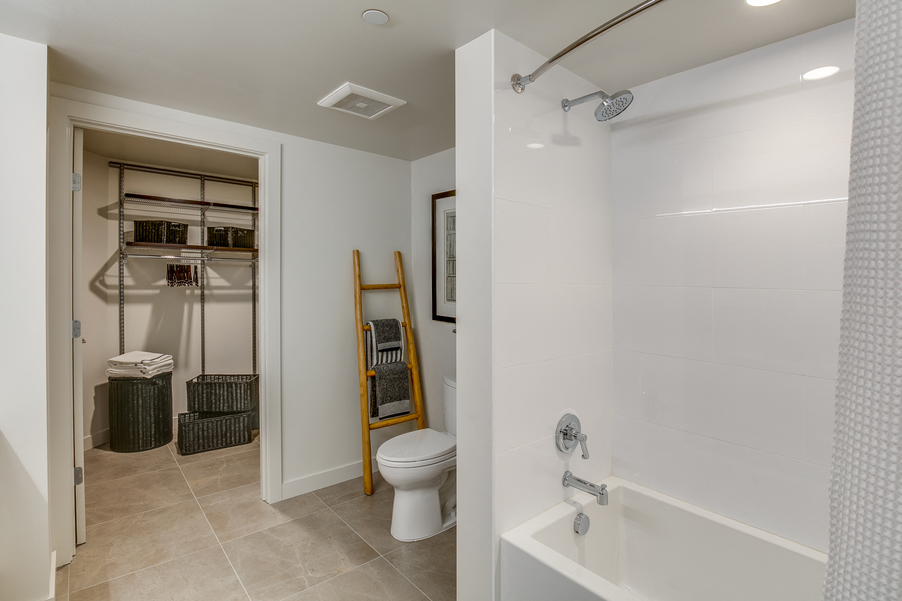 a bathroom with a shower and a toilet and a ladder