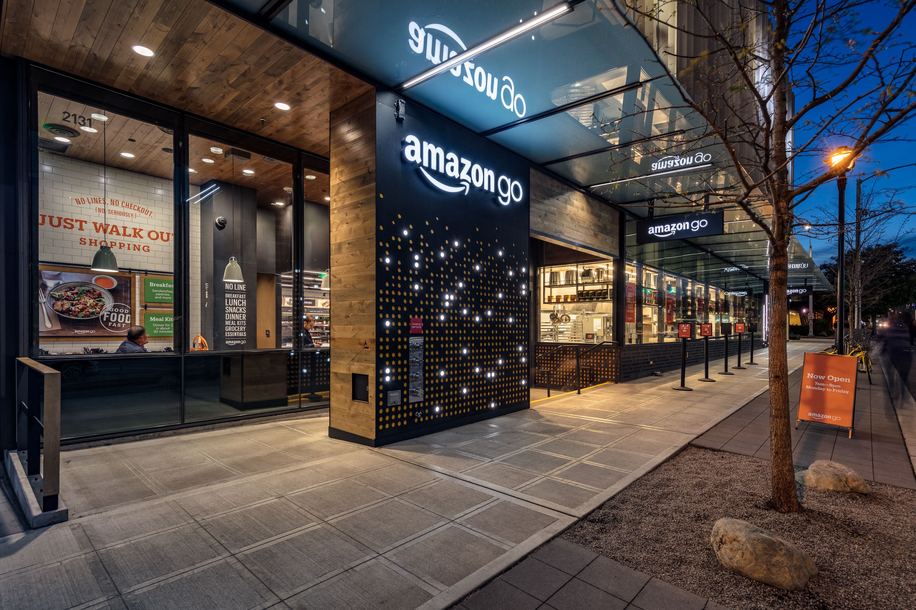an store at night with lights on the front of the building