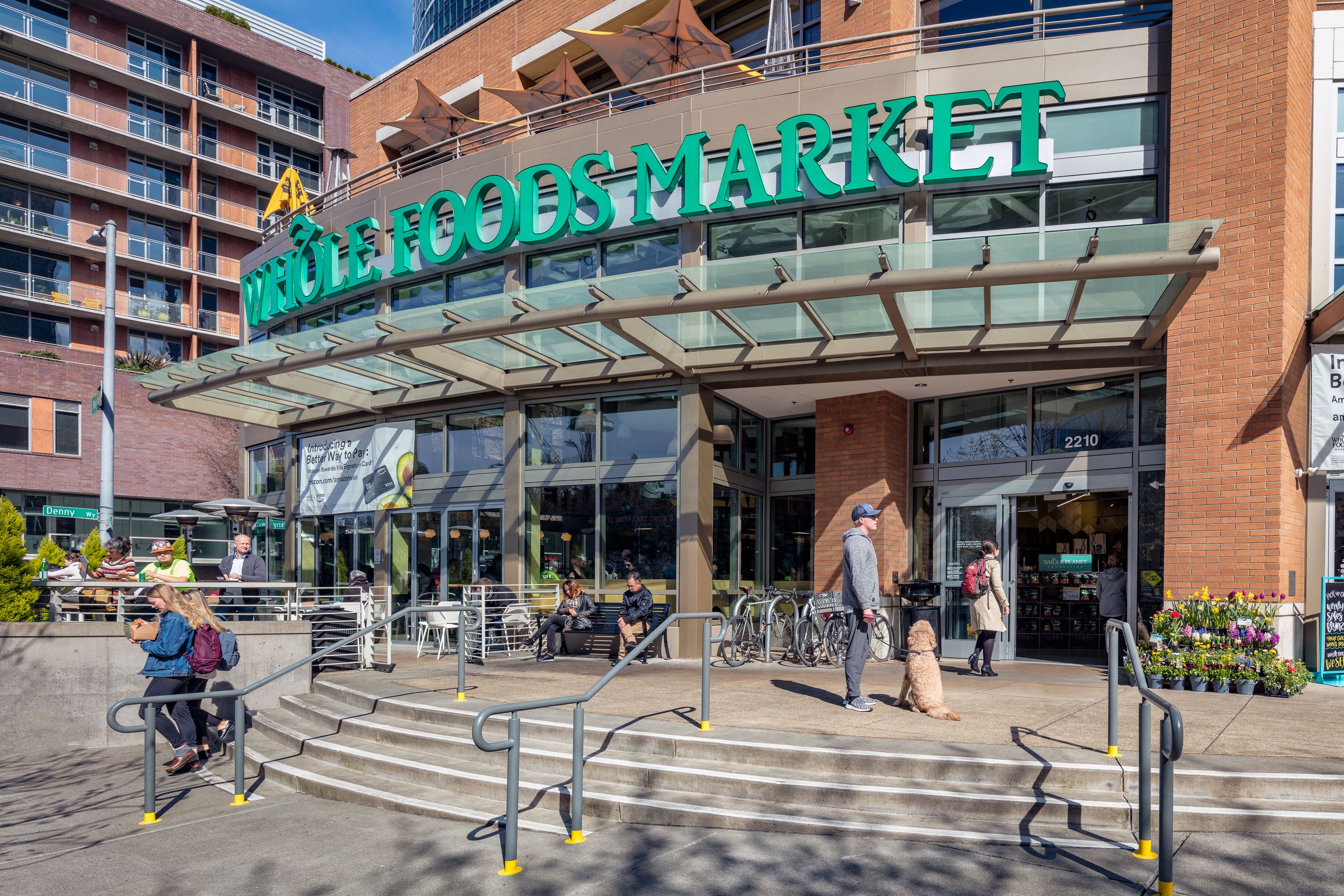 people walking in front of a shopping mall