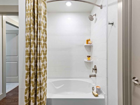a bathroom with a shower and a tub and a shower curtain