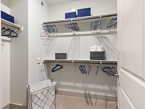 a walk in closet with a rack of golf clubs and baskets