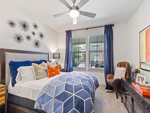 a bedroom with a bed and a ceiling fan