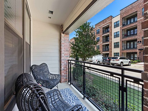 our apartments offer a balcony with chairs and a view of the city